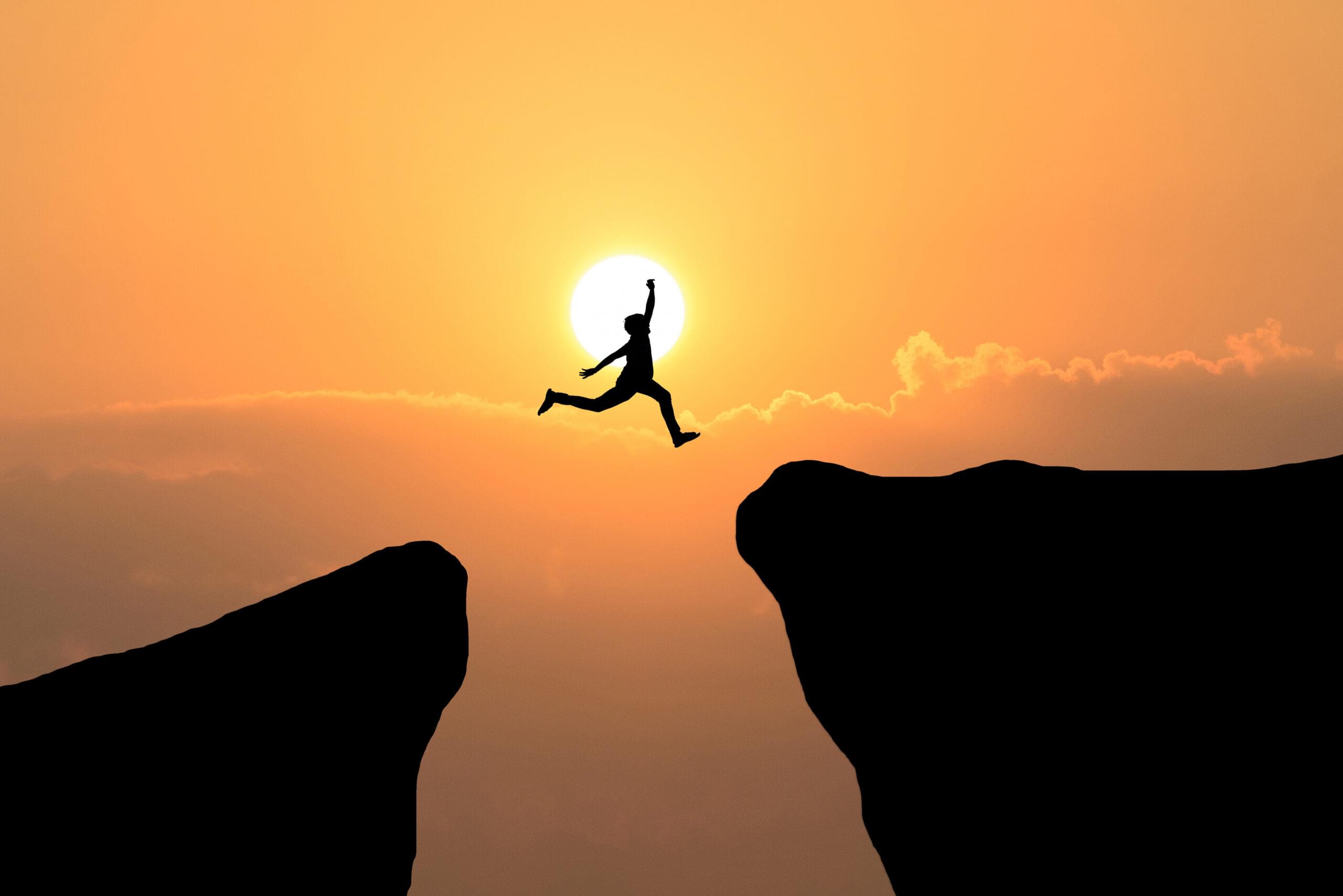 courage man jump through gap hill business concept idea scaled